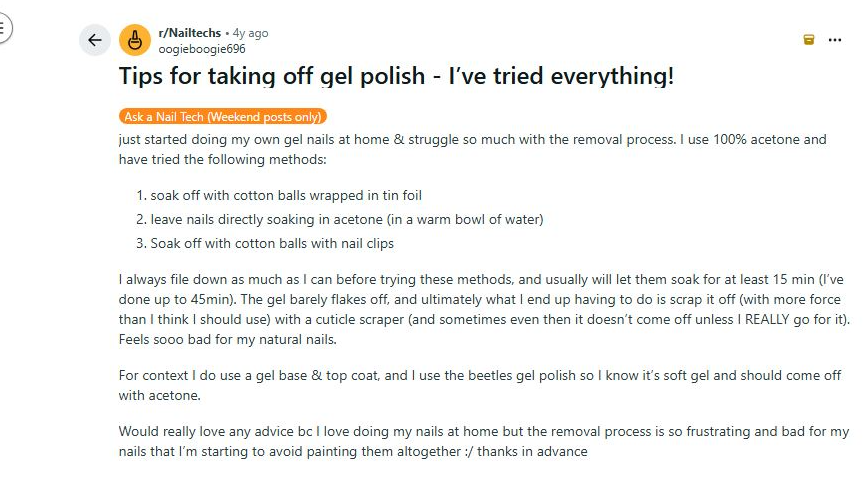 A close-up of a Reddit user's nails showing the process of gently using a metal cuticle scraper to remove stubborn gel polish after an acetone soak.