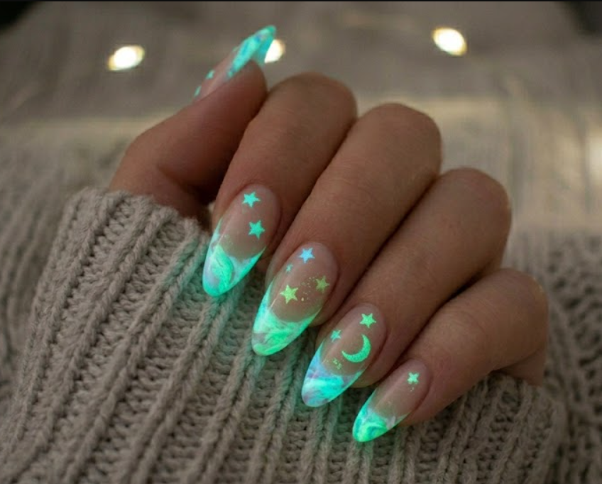 Long almond nails with glowing mint blue and green marble french tips and star decals.