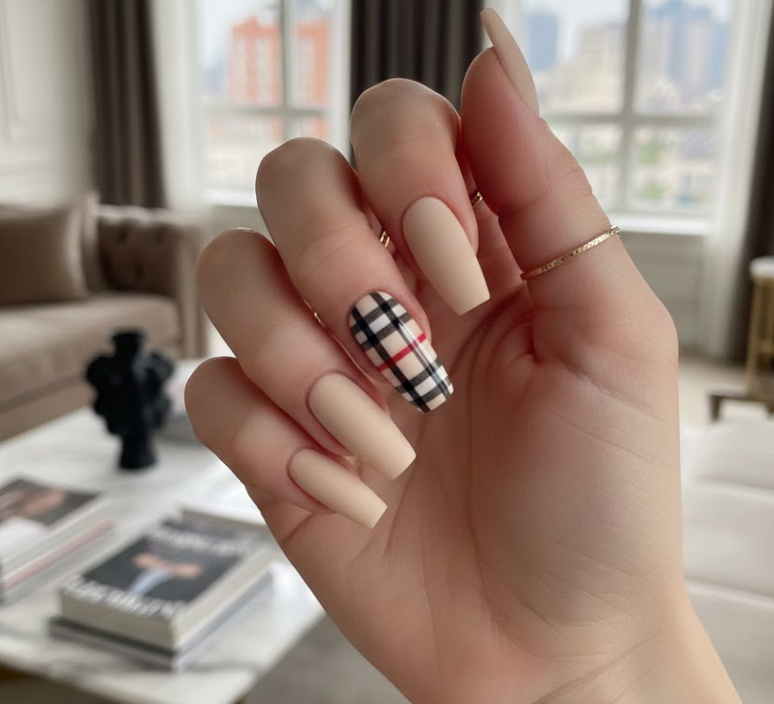 Most nails are matte, but one plaid nail is shiny and glossy