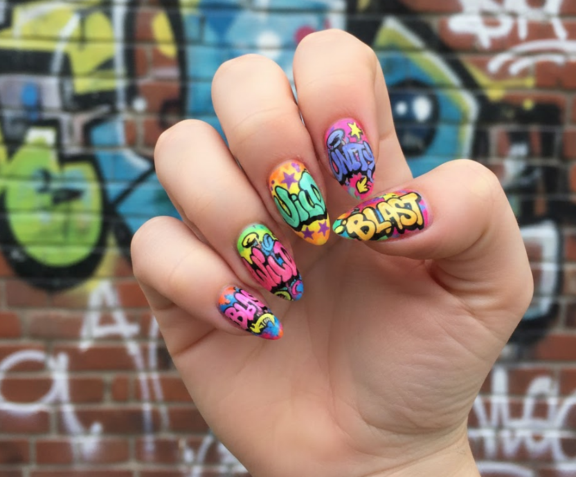 Bubble-style lettering on nails, featuring initials or words like “RISE” or “BAM!” for personal graffiti nails flair