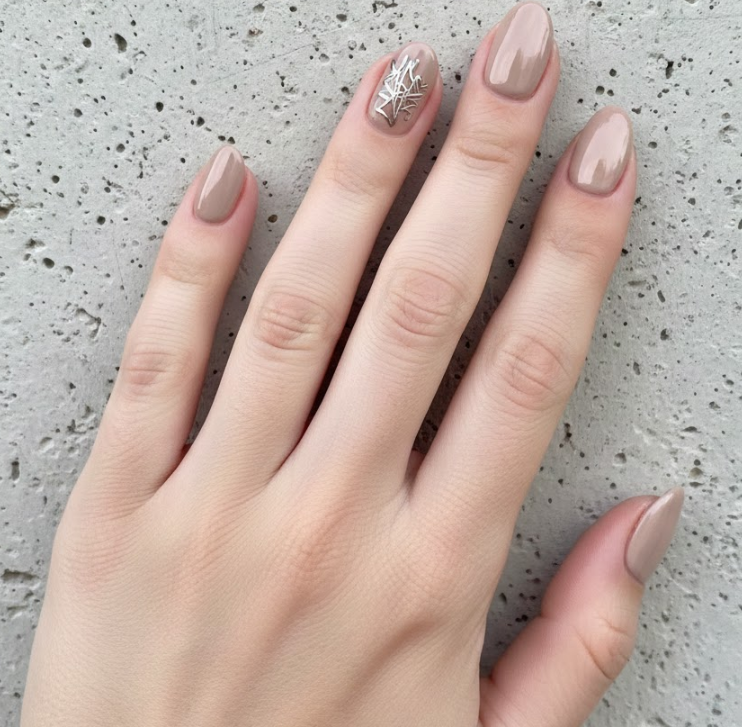 Nude base with a tiny metallic squiggle or star, minimalist graffiti nails accent