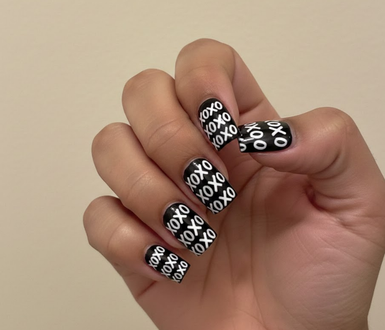 Black nails with white or gold XOXO patterns, fun and retro