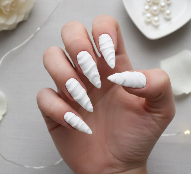 White nails sculpted into flowing 3D waves, bold, minimal, and modern white valentine nails