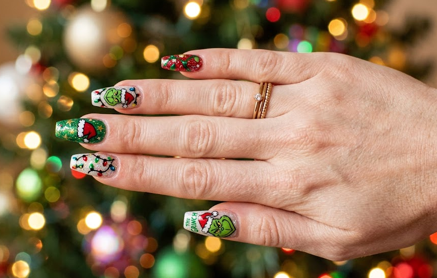 Colorful Christmas lights on base with Grinch illustration.