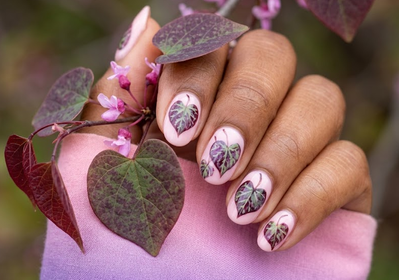 Redbud (Forest Pansy) – Round shaped nails: Light pink base, purple-green redbud leaves, ombre pink-purple, scattered clusters.