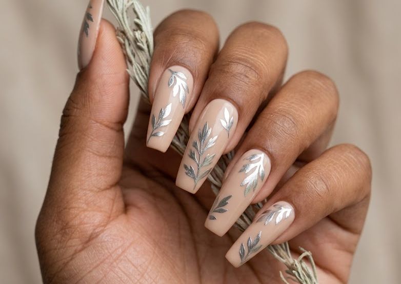 Silver Sage – Coffin shaped nails: Nude beige base, metallic silver sage leaves, minimalistic spring nails, classy design.