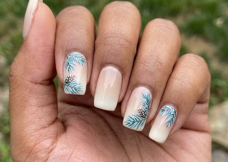 Blue Spruce – Square shaped nails: Beige base, blue-green spruce leaves at corners, gradient base, stylish summer nails.