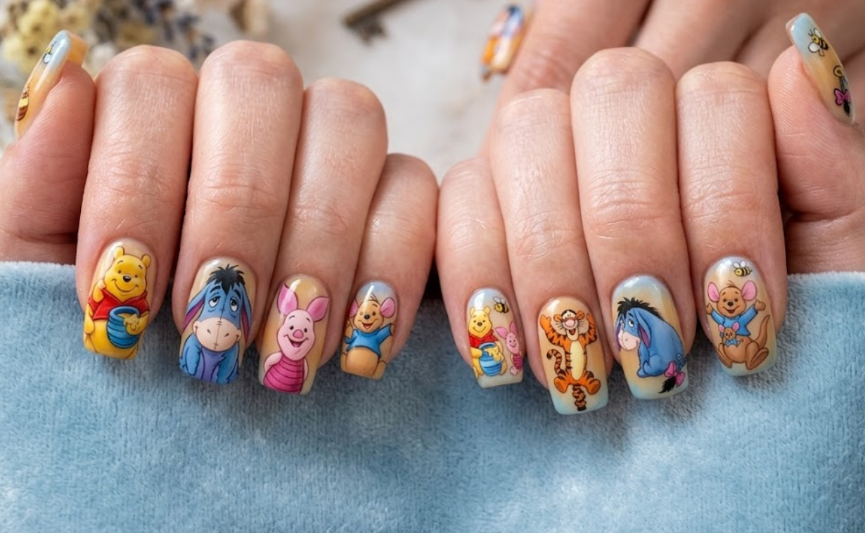 This nail design shows Pooh with all his friends (Piglet, Tigger, Eeyore, Rabbit, and Owl) on different nails, creating a complete cartoon world and a colorful story-like feel.