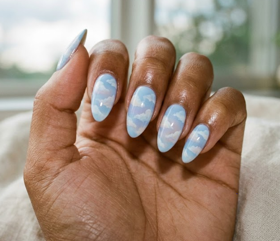 This nail art shows Winnie the Pooh under a cloudy sky 