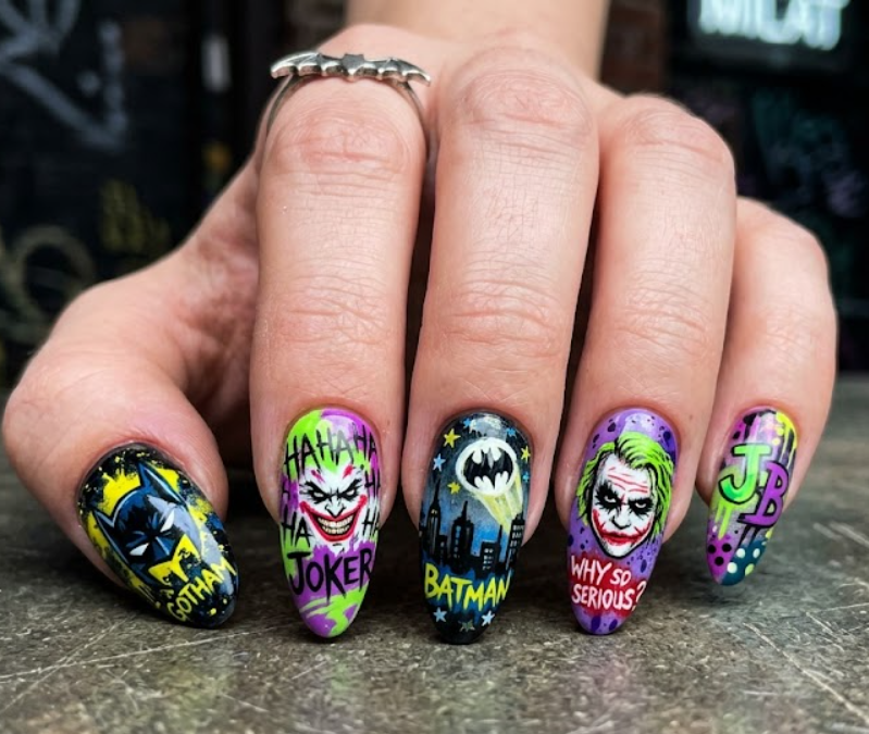 Full hand Batman Joker chaotic neon green and purple graffiti-style nails on a simple background