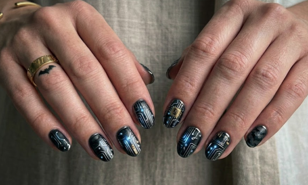 Full hand Batman Lucius Fox futuristic chrome nails with metallic circuit patterns on a simple background