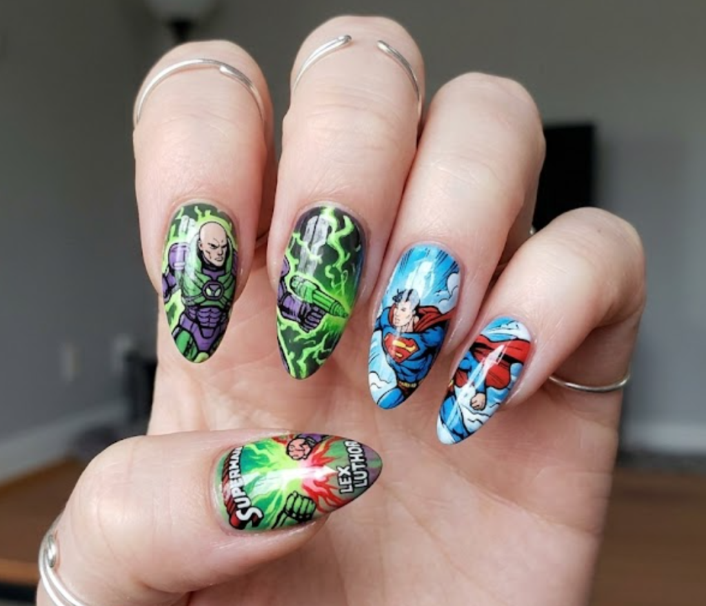 A woman’s hand showing Superman facing Lex Luthor with green energy effects and blue sky contrast.