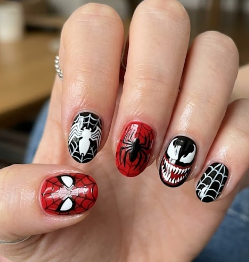 Dark Venom inspired nail design with glossy black chrome nails, dripping web effects, and sharp white spider eye details.