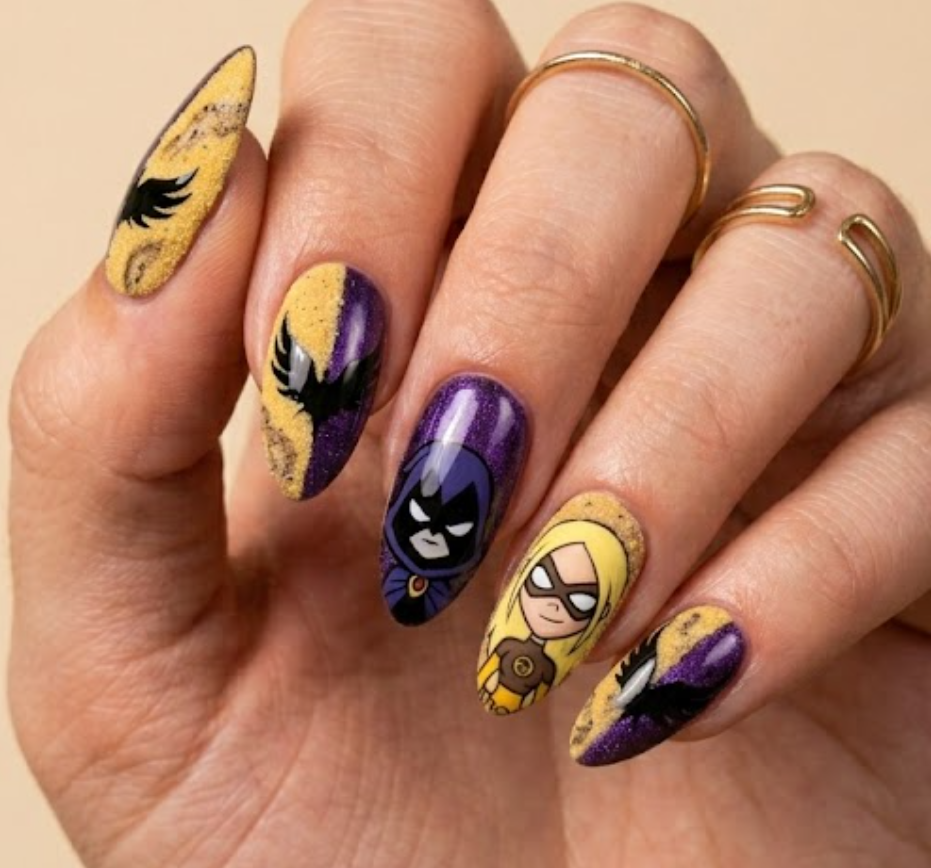 Round shaped nails contrasting a rough sand-textured yellow gold for Terra against a glossy dark purple wing design for Raven.