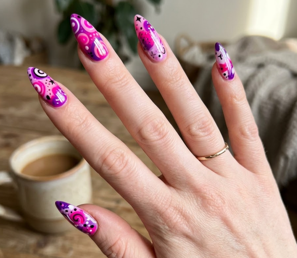 Close-up photo of a woman’s hand with white skin in an energetic spread-finger pose, stiletto-shaped nails.