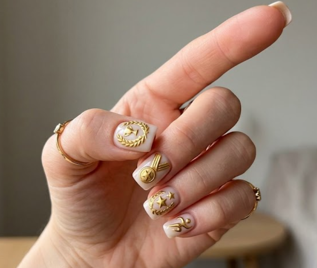 Close-up photo of a woman’s hand with white skin in a sporty pointing gesture pose, square-shaped nails.