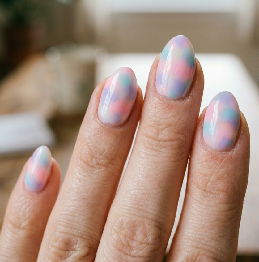 Close-up photo of a woman’s hand with white skin in a soft romantic slightly bent finger pose, almond short-shaped nails.