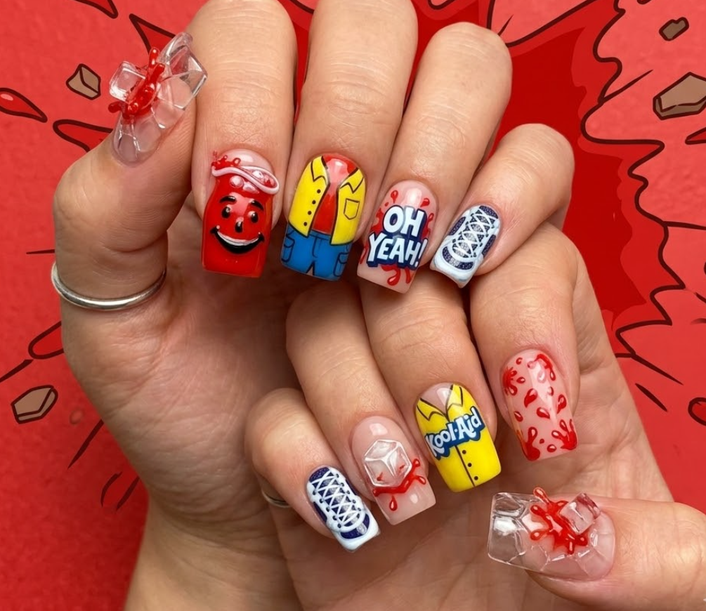 This photo shows full hand Kool-Aid Man inspired nails with explosive bright colors, bold glass-shatter effect, chunky square nail shape, and simple red splash background.