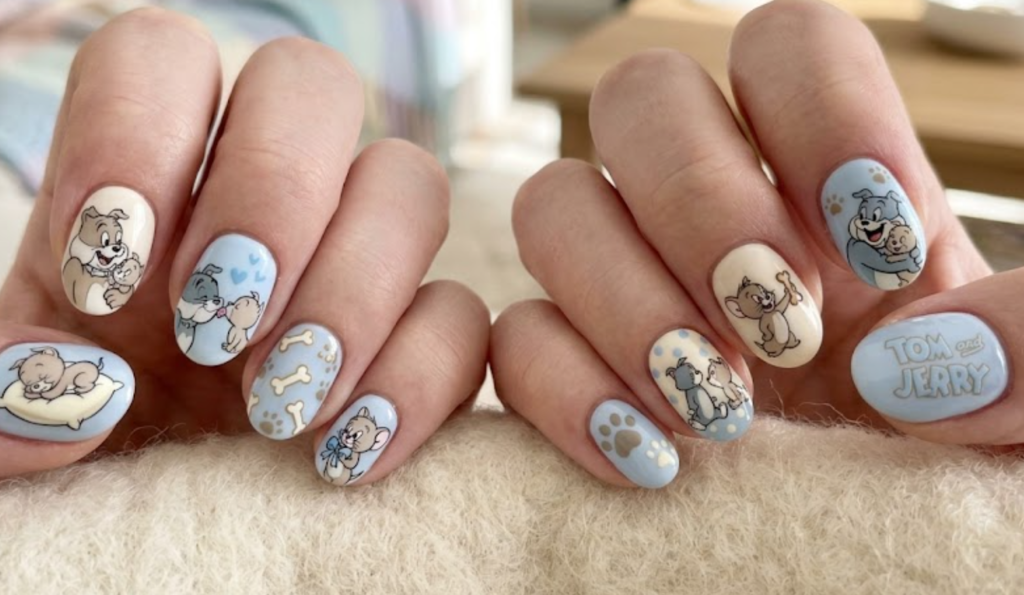 Round-shaped Spike and Tyke nail design with soft pastel tones and a cute bonding theme.