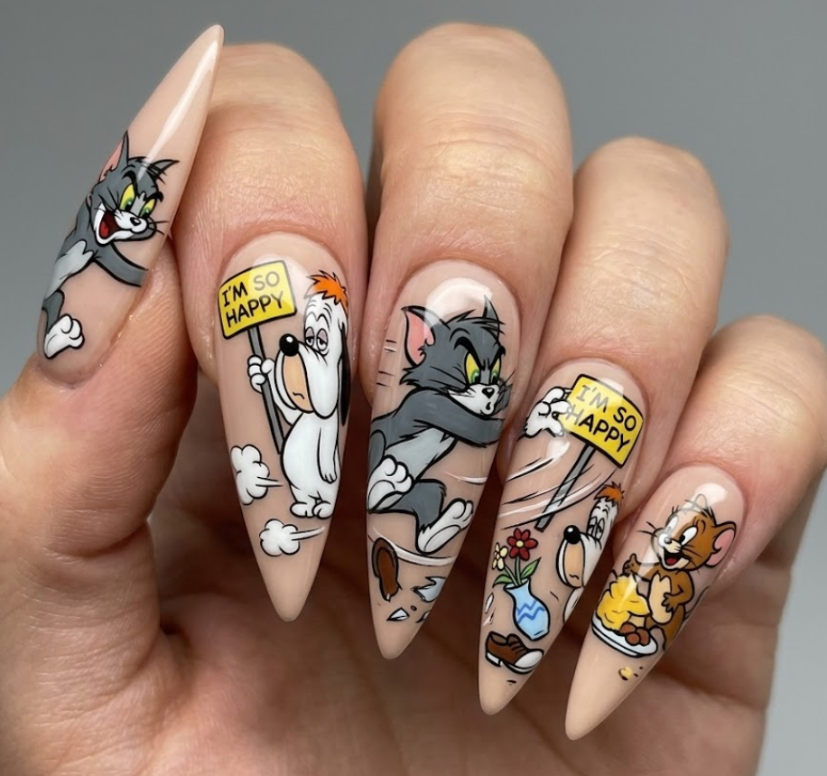 Stiletto-shaped Tom and Meathead dog nail art with funny chase scenes and bold cartoon expressions.