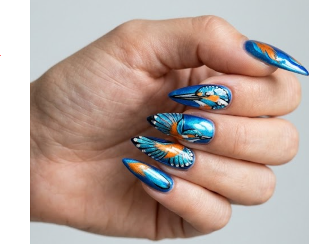 In this picture, stiletto nails feature electric blue and orange kingfisher-inspired metallic nail designs.
