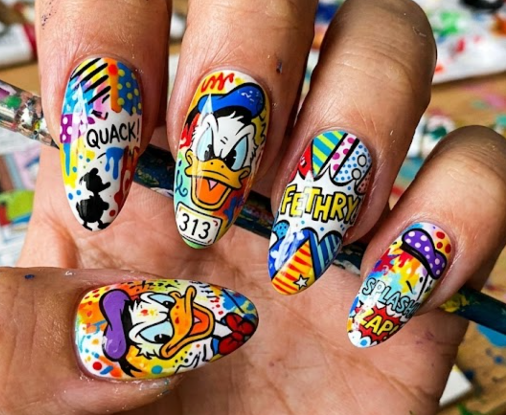 Fethry Duck inspired colorful nail art with quirky patterns, bright colors, and playful cartoon elements.