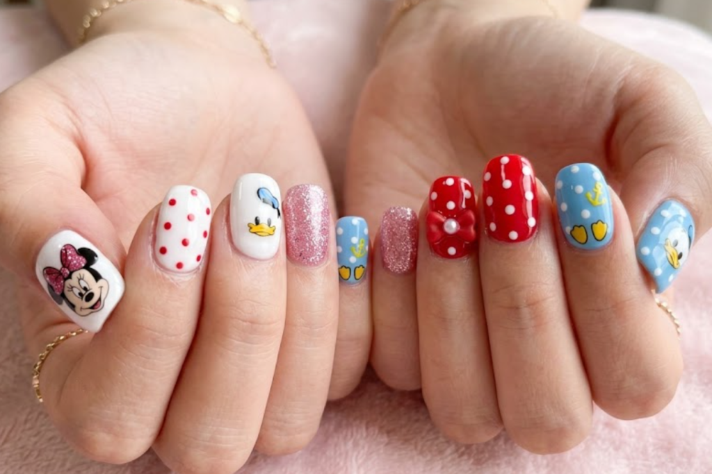 Mickey Mouse inspired red and black nail design with classic mouse ears and Disney cartoon elements.