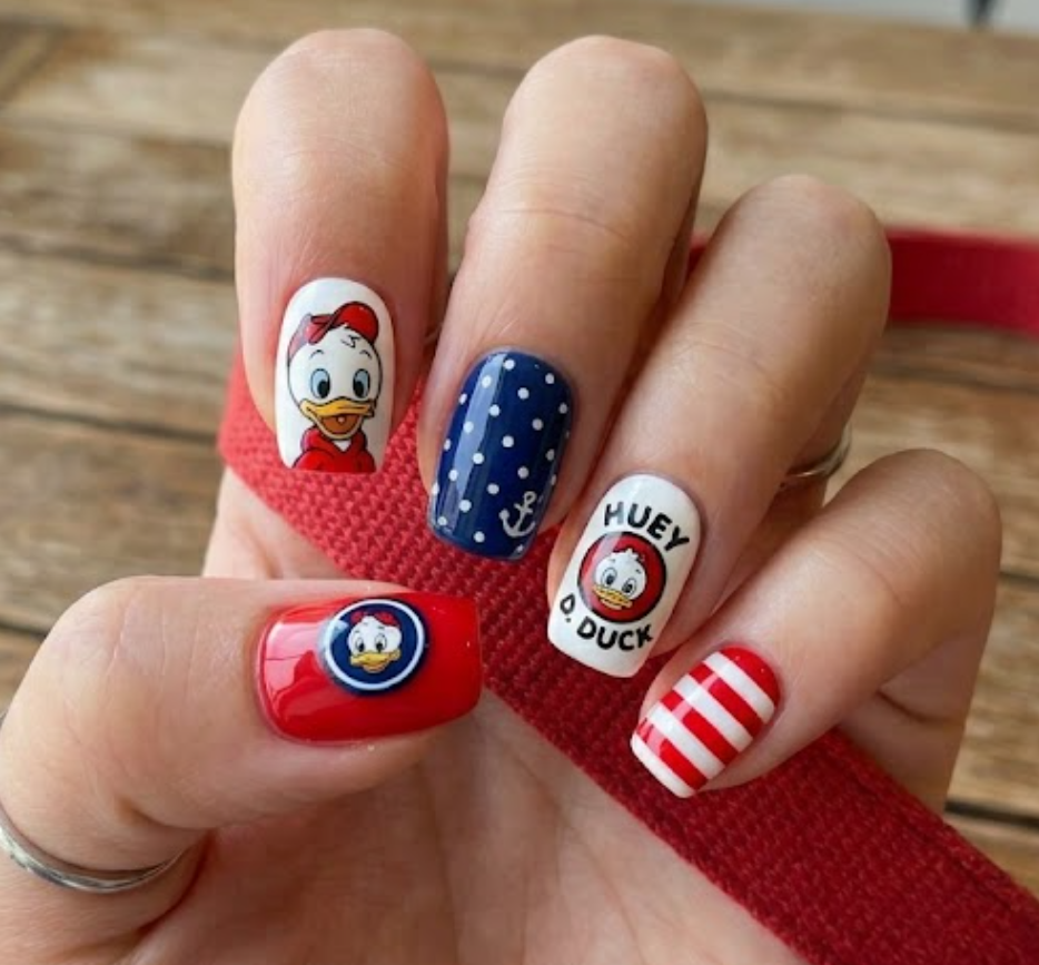 Huey Duck inspired red hoodie nail design with small duck icons and playful cartoon-themed details.