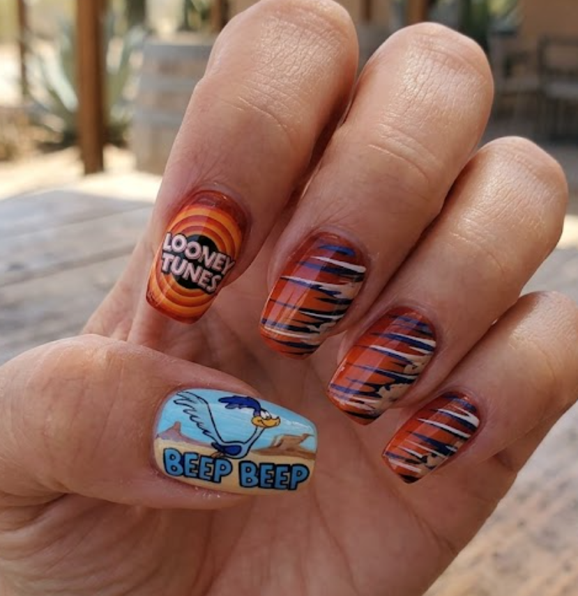 In this photo, energetic Road Runner Looney Tunes nail art with speedy cartoon vibes.