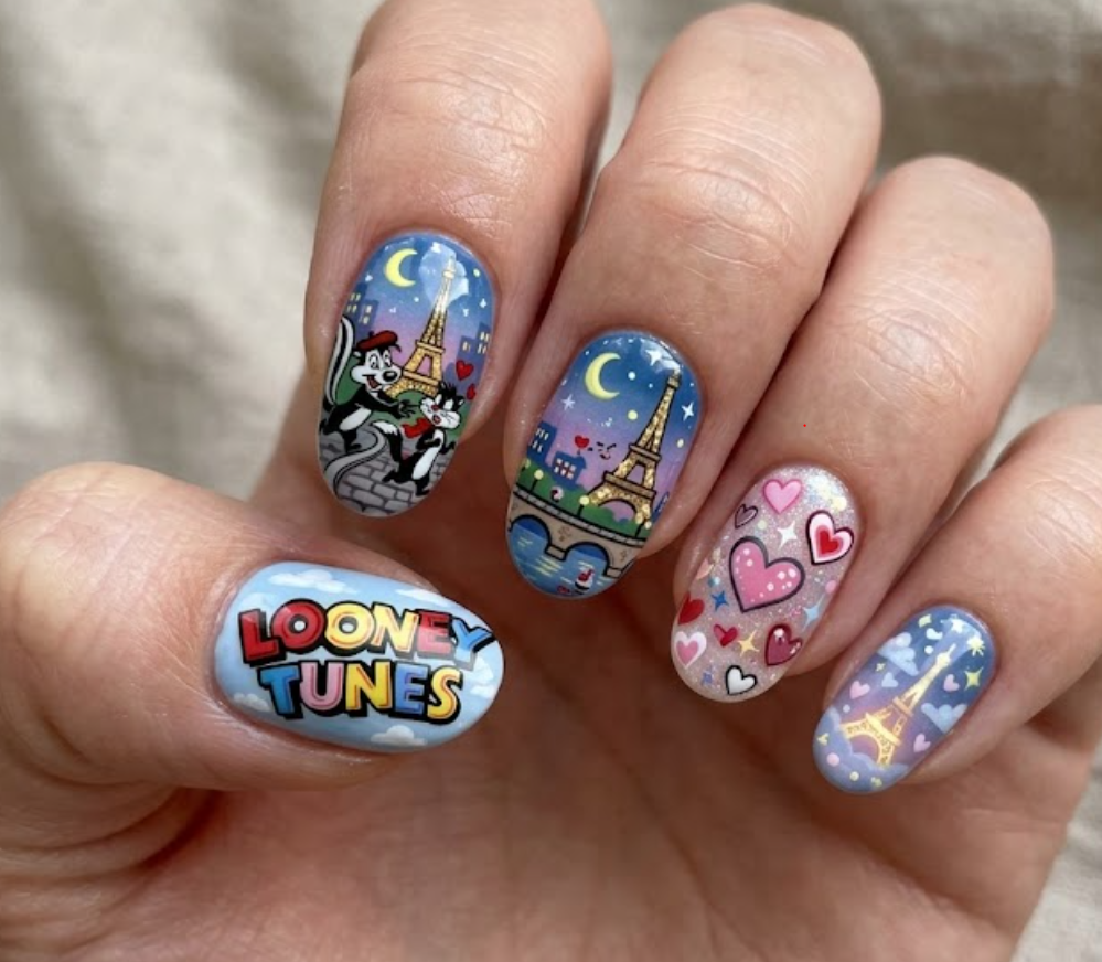 In this photo, charming Pepe Le Pew Looney Tunes nail art with cute romantic cartoon vibes.