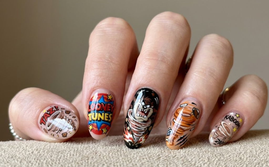 In this photo, bold Tasmanian Devil Looney Tunes nail art with wild and playful cartoon energy.