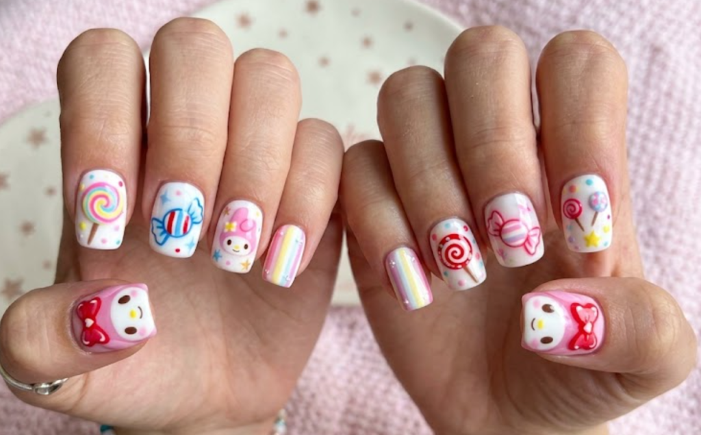 Candy Wonderland My Melody manicure with lollipops, candy swirls, and wrapped sweets.
