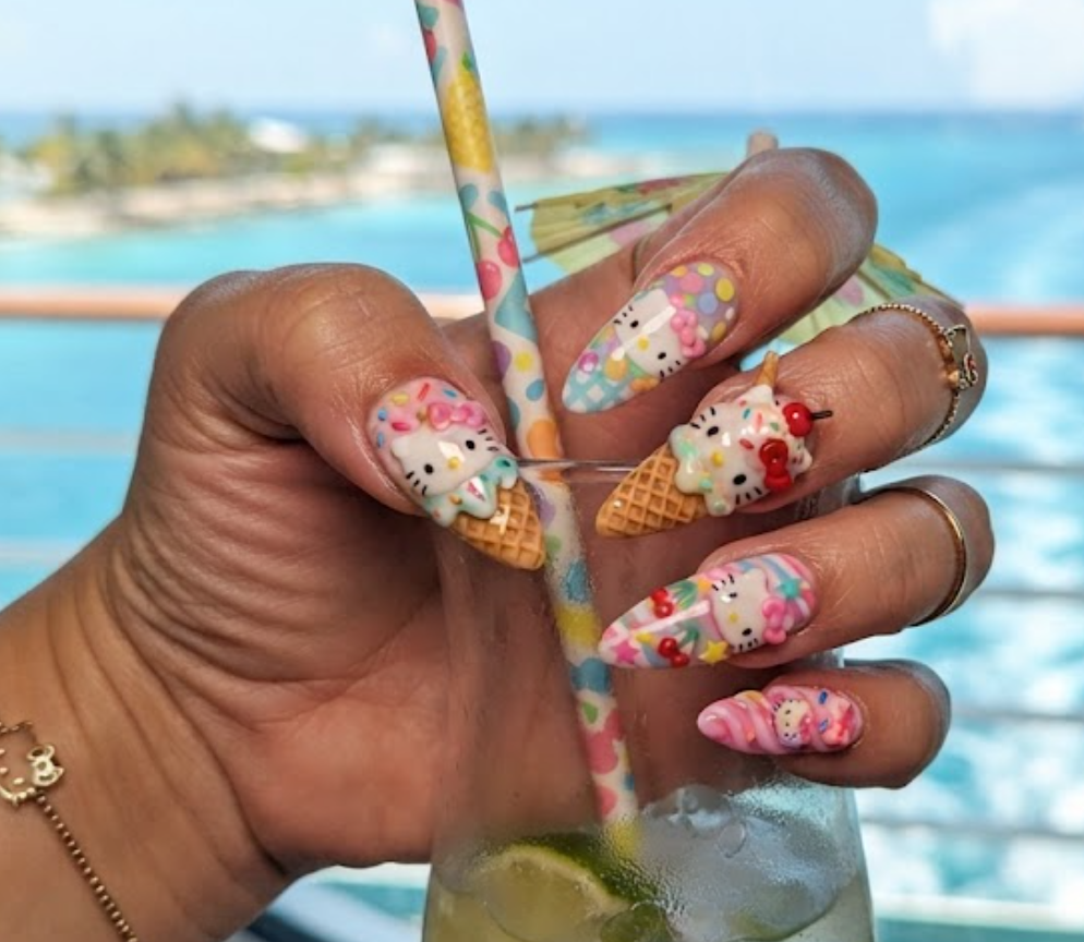 Playful Hello Kitty manicure close-up with ice cream cone nail art.
