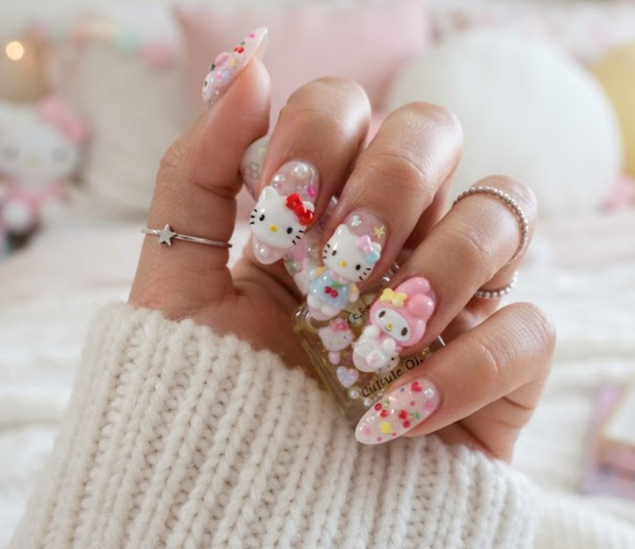 Full hand close-up of Hello Kitty and My Melody themed Sanrio nail art.