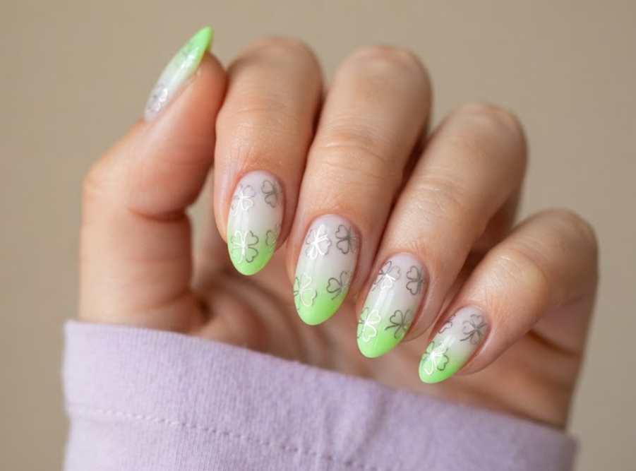 In this image, clean nails showcase neon green chrome ombre 4-leaf clover art while wearing a lavender shirt.