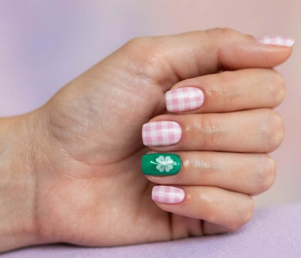 In this image, a graphic 4-Leaf Clover Nail displays a pink and white checkered pattern and a green clover with a lilac shirt.