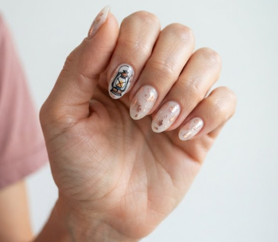 in this image real hands feature glamping metallic foil camp nail art. camp inspired nail design