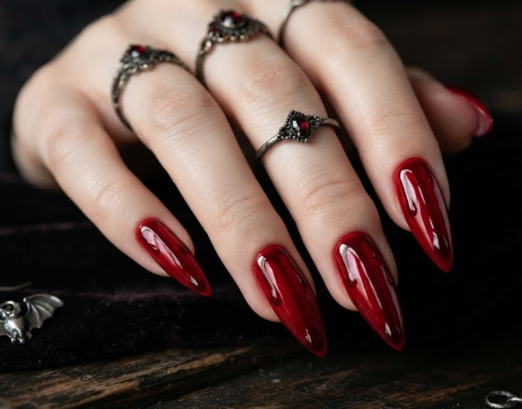 In this photo, deep crimson nails with glossy blood drips create a striking vampire-inspired manicure.