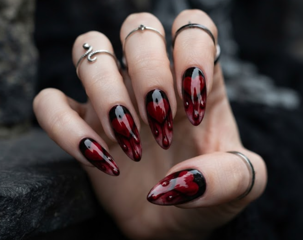 In this photo, heart-shaped nail art with realistic bleeding details creates a dramatic romantic gothic look.