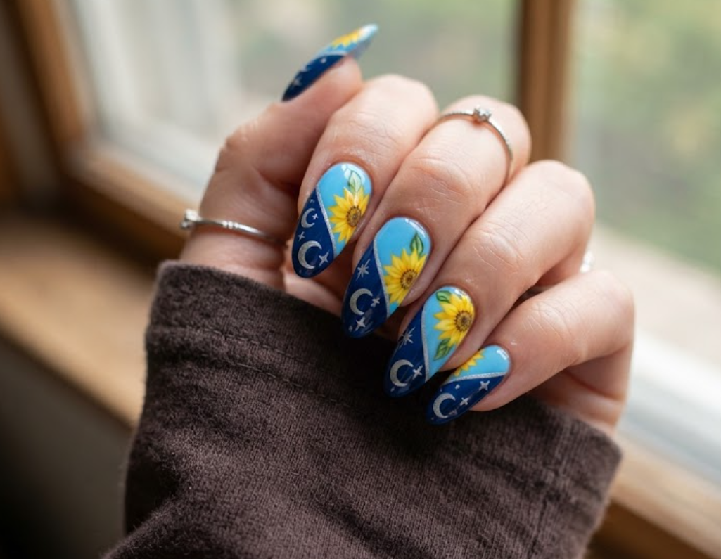 In this image, real hand nails feature split diagonal night-and-day sunflower designs with a dark brown shirt.
