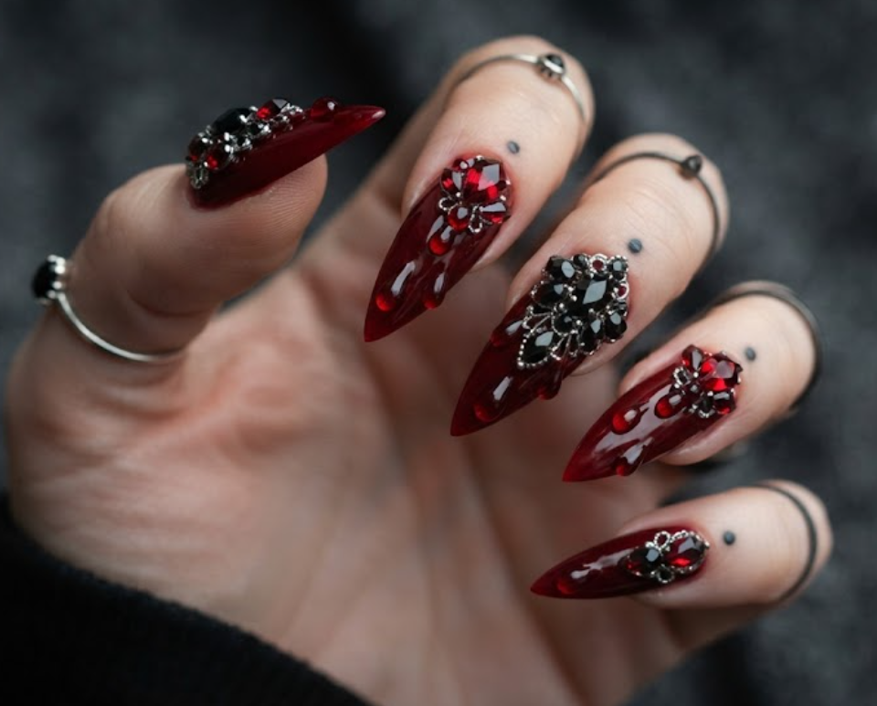 In this photo, sparkling red gems resemble realistic blood drops for a glamorous gothic manicure.