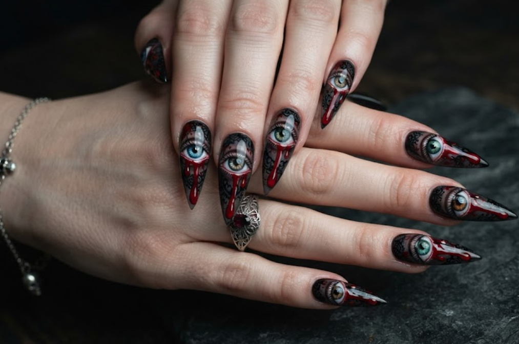 In this photo, eerie eye artwork with blood tears gives the nails a creepy all-seeing horror theme.