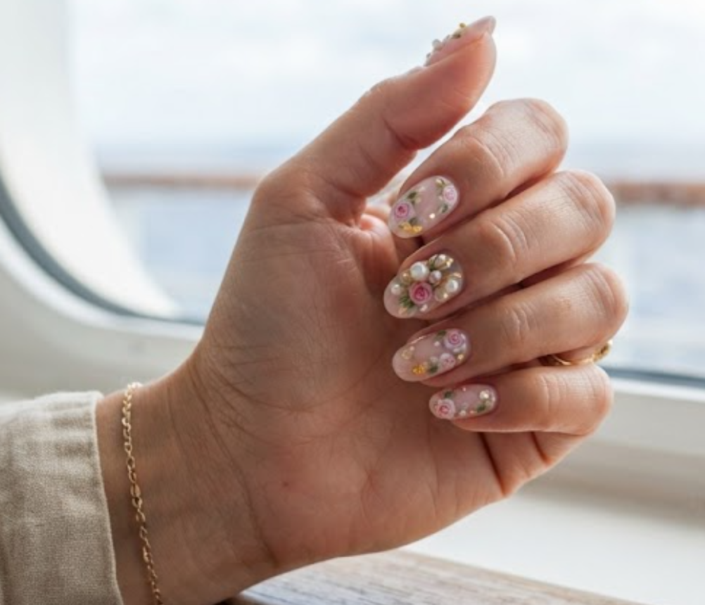 In this image, full hand nails feature Pink Pearl Garden cruise nail ideas.