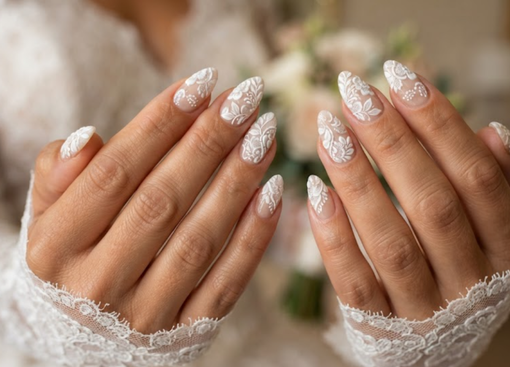 In this image, cruise wedding nails display short almond sheer nude nails with embossed white bridal lace patterns, worn by hands in a white lace sleeve.