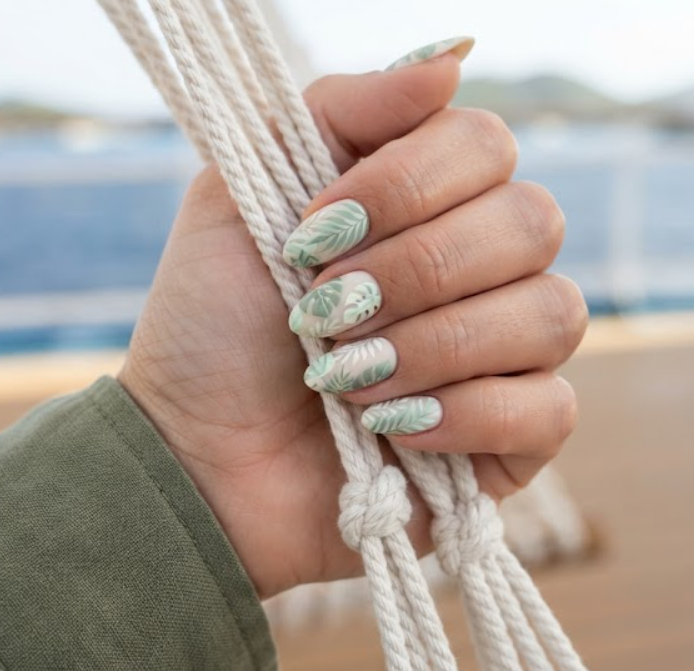 In this image, full hand nails feature Island Breeze Leaves cruise nail ideas.