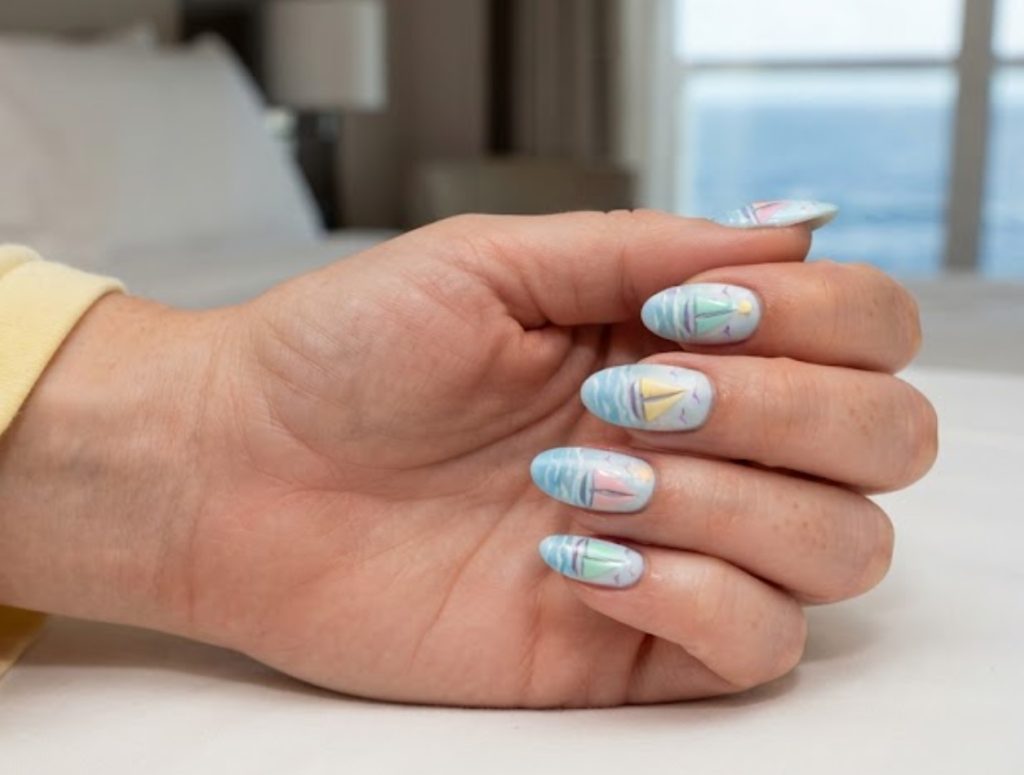 In this image, full hand nails feature Pastel Sail Adventure cruise nail ideas.