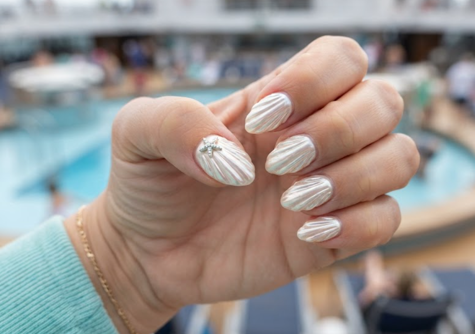 Textured 3D white seashell honeymoon nails with a pearl chrome finish and a starfish accent.