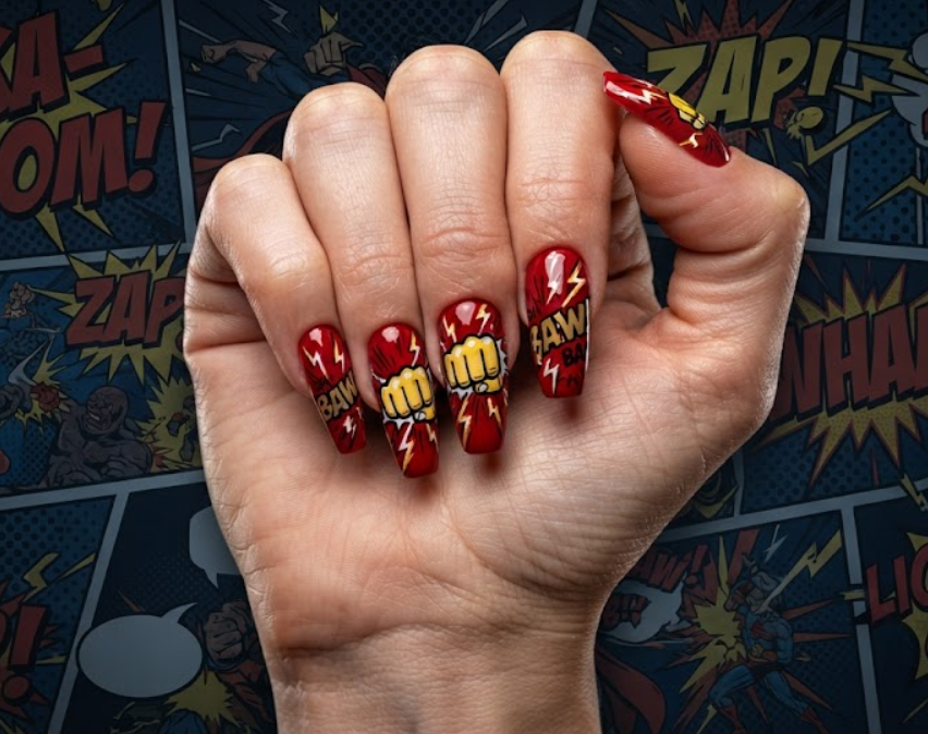 In this image, red comic nails feature cartoon fists, lightning bolts and bold action lines.