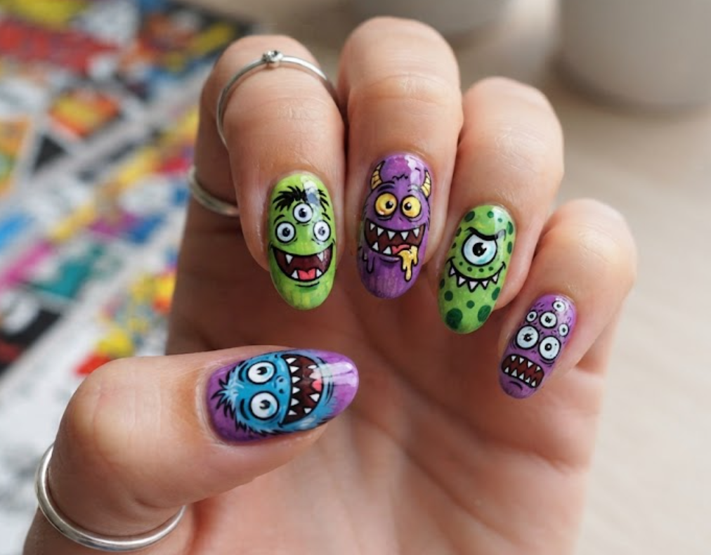 In this image, green and purple comic nails feature colourful monster faces, sharp teeth and GRRR effects.