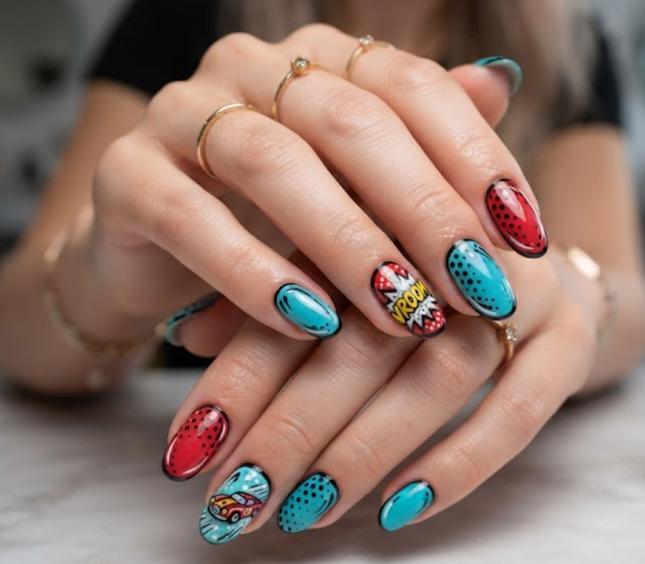 In this image, turquoise and red comic nails feature a vintage racing car and VROOM speed effects.